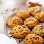 close up of pumpkin chocolate chip cookies on round plate