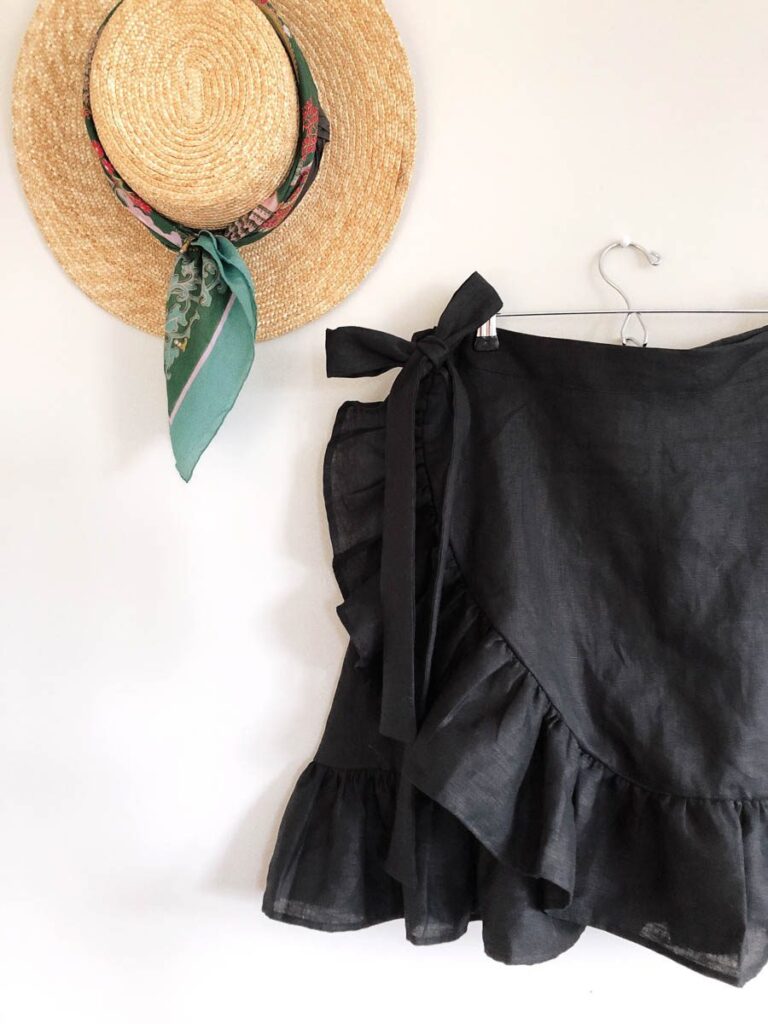 Wrap skirt in black linen hanging on wall 