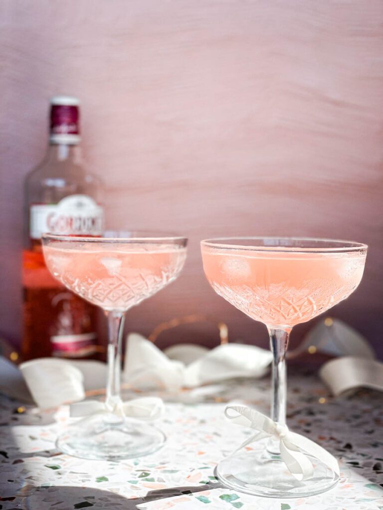Two sparkling Gin Cocktails with Grapefruit juice in tall crystal glasses.