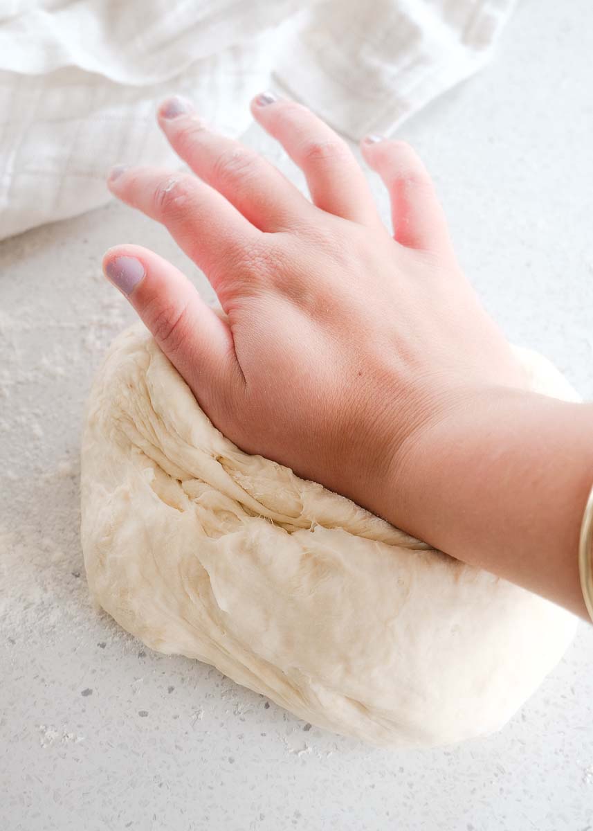 step four kneading the dough by fully pressing in palm