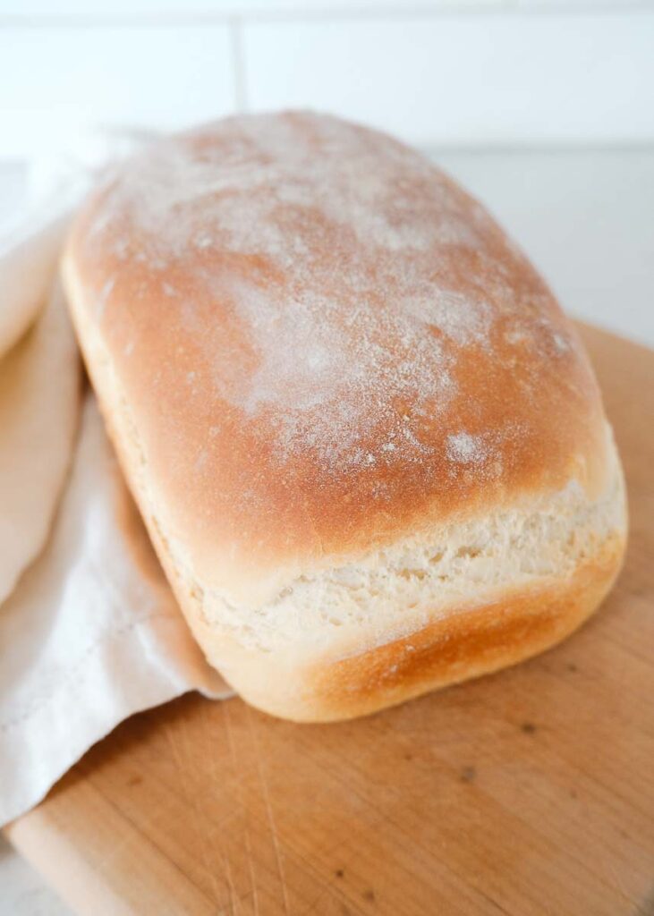 Loaf of freshly baked farmhouse white bread dusted with flour