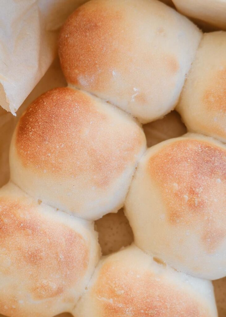 close up of top of dinner rolls that are golden brown