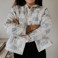 Makyla wearing her handmade quilt jacket with her arms crossed