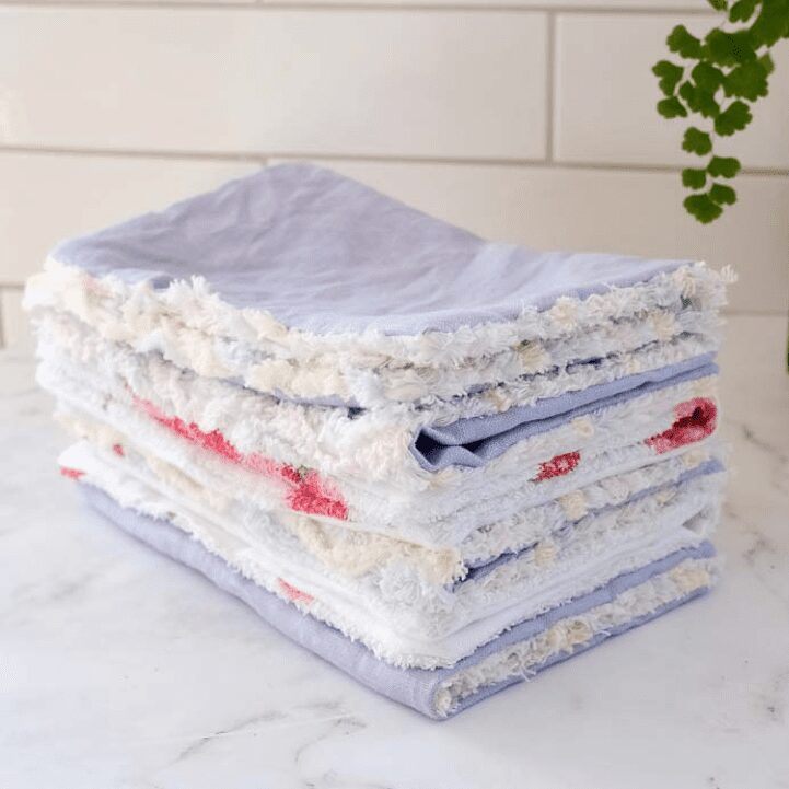 Stack of unpaper towels made in linens and cottons on kitchen bench
