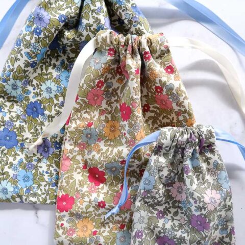 Set of three different sized drawstring bags in floral cotton prints