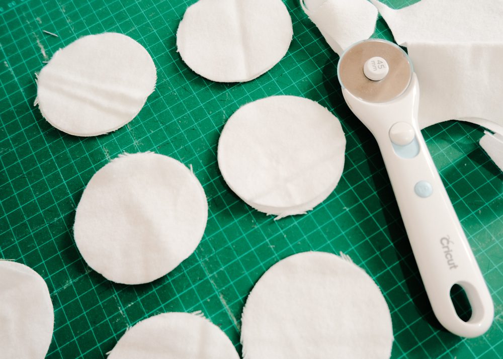 Cutting out terry cloth fabric into circles to make reusable cotton pads
