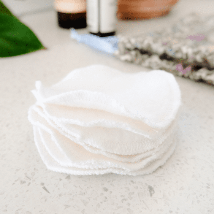DIY Reusable Cotton Pads in a pile on bench by a green plant