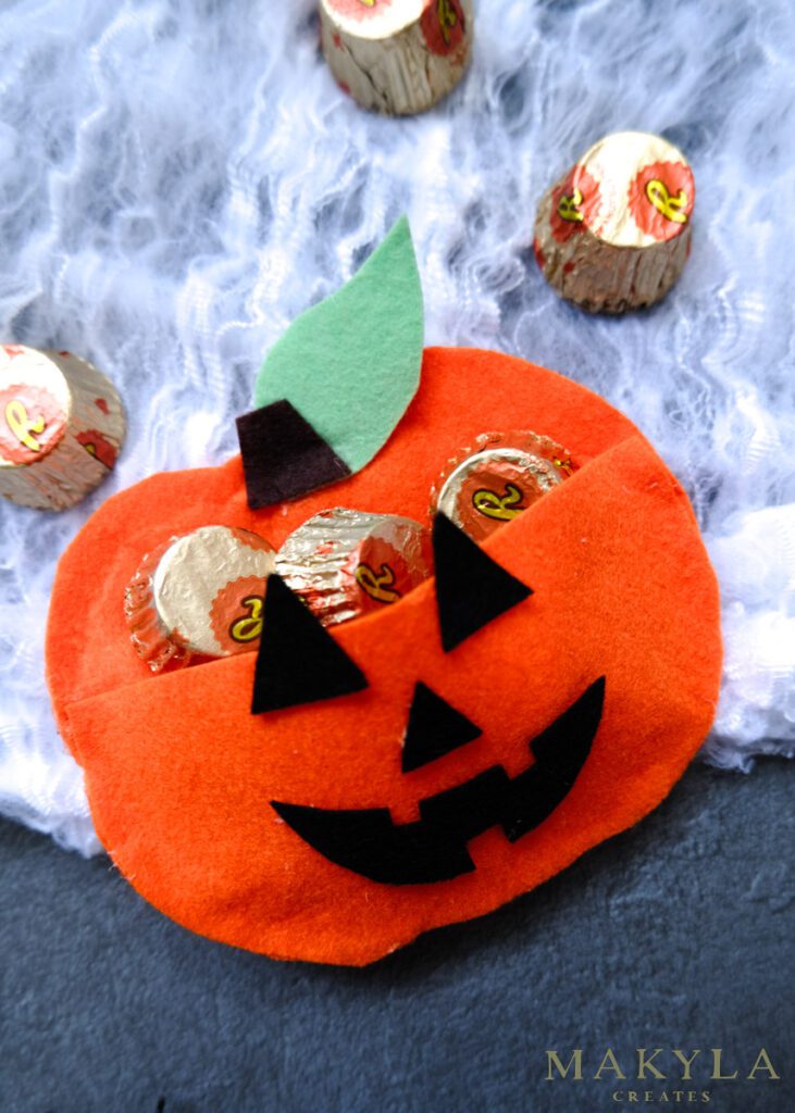pumpkin treat bag made from felt fabric filled with candy
