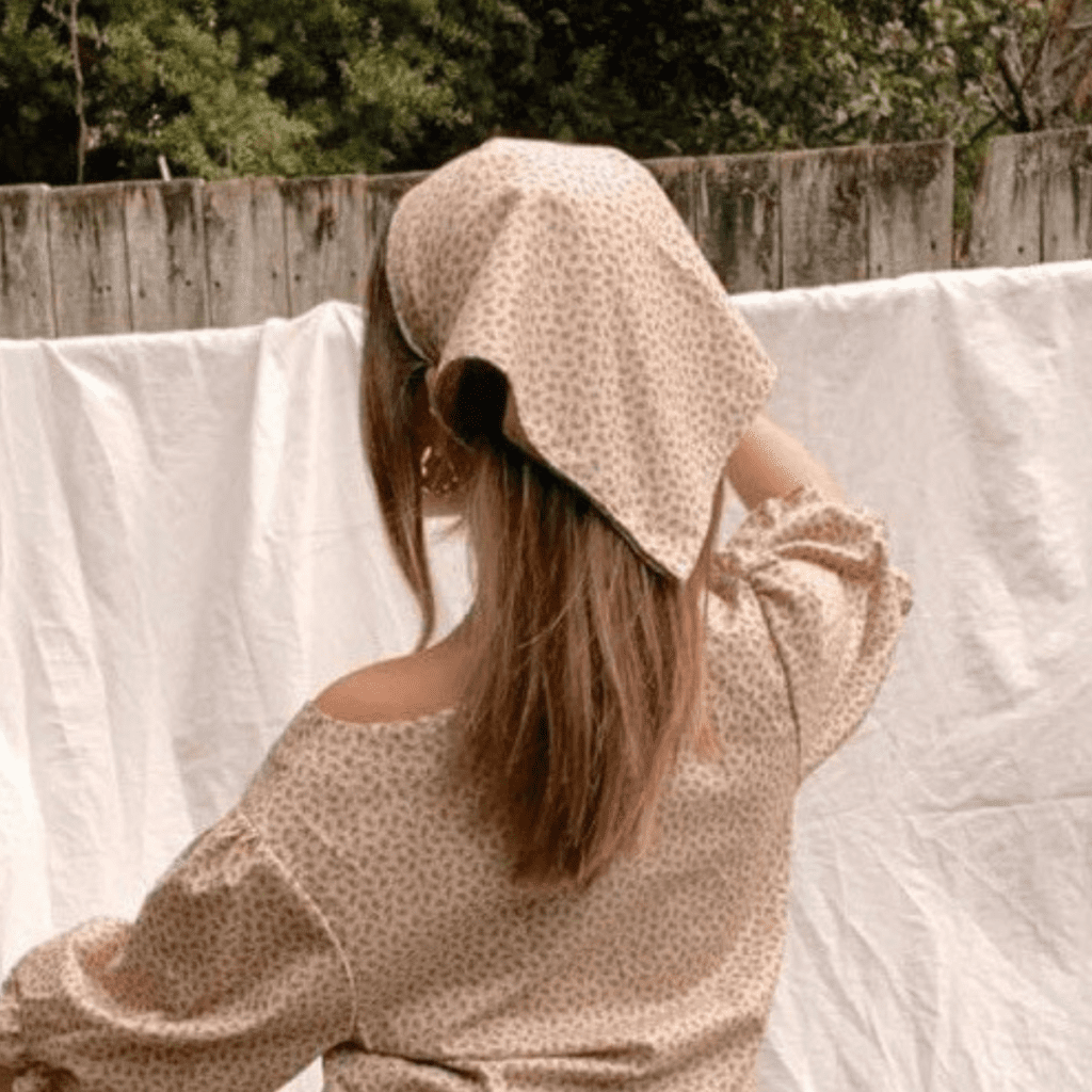 Phibae wearing a handmade bandana in a vintage tan cotton fabric