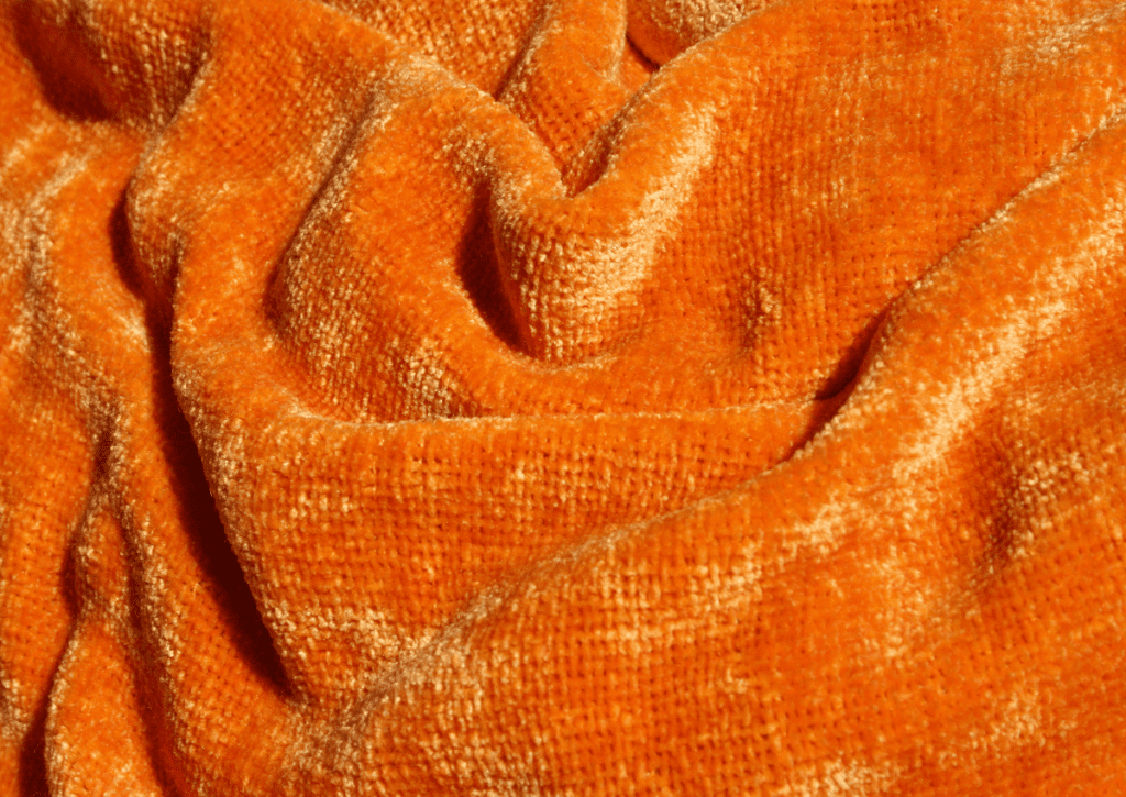 Close up image of orange chenille fabric