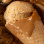No churn Dulce de Leche ice cream scooped into a waffle cone