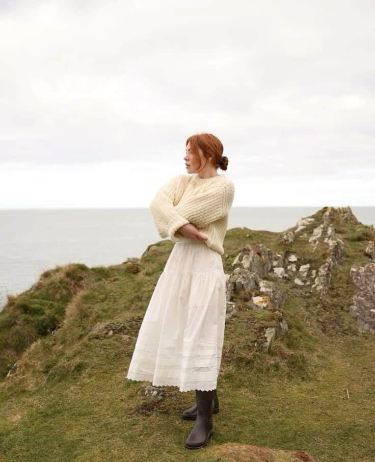 Girl in knitted jumper and skirt