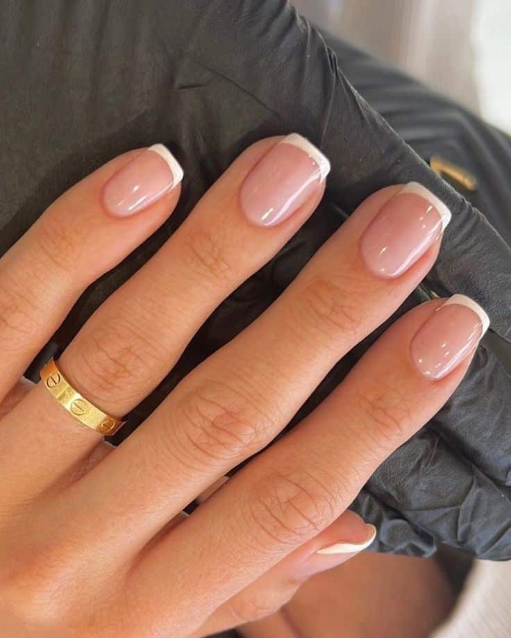 Short square nails with a classic white French tip on a natural pink base