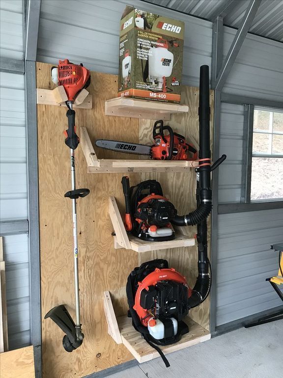 Vertical wood shelf system storing trimmers, blowers, and a chainsaw