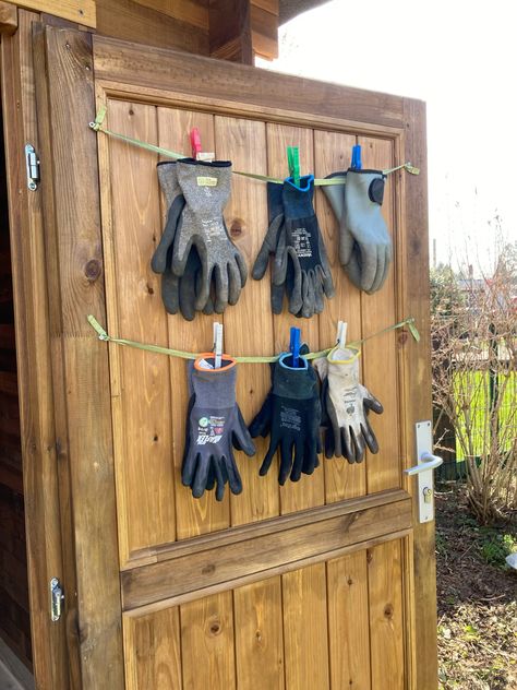 Clothesline with clothespins holding garden gloves to dry