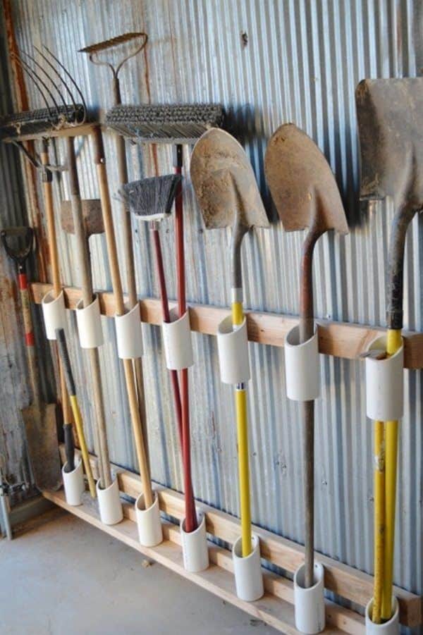 PVC pipe holders mounted on a board for long handled garden tools