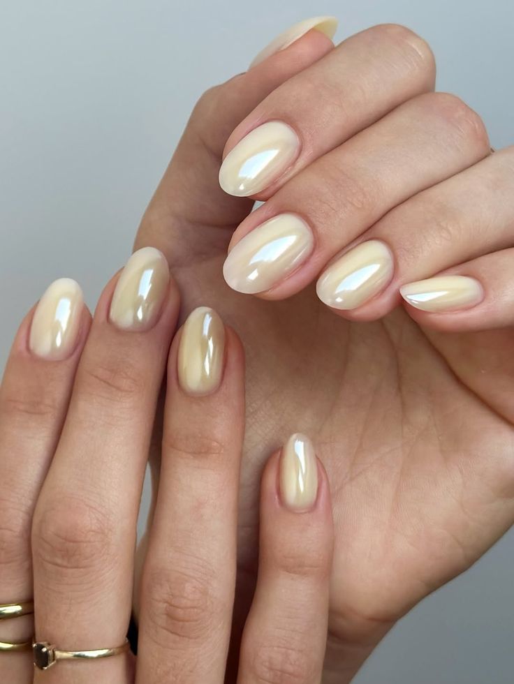 Almond nails in a creamy butter yellow chrome with a high shine mirror finish.