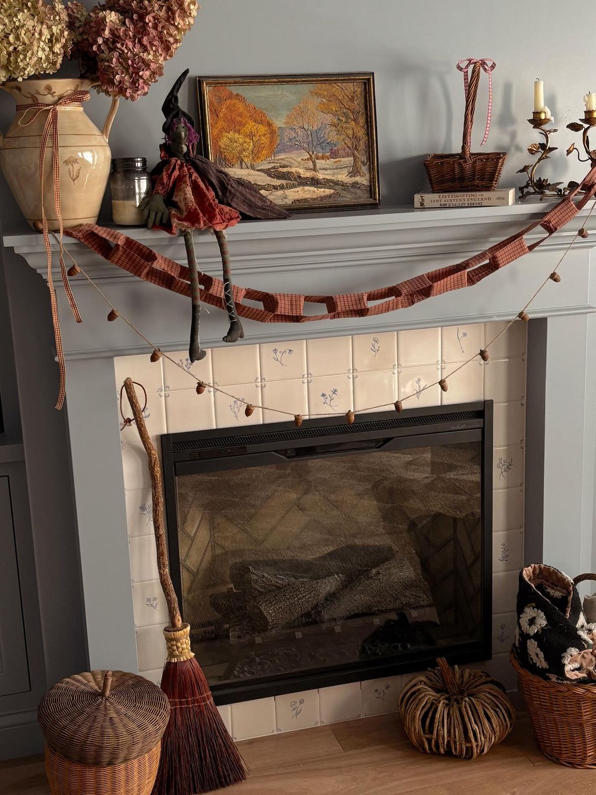 Primitive fall fireplace with a fabric paper chain garland and a little witch doll