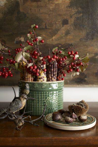 Indian corn and crabapple branches arranged in a green vintage cachepot