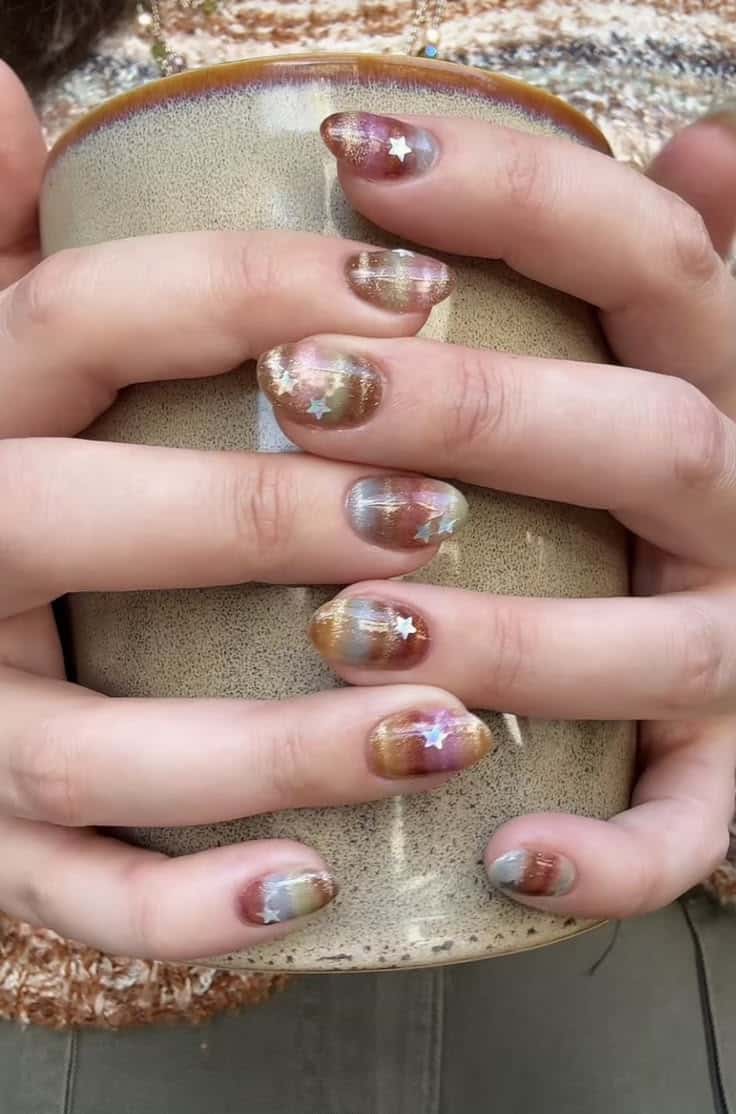 Warm bronze velvet cat eye nails with star studs for fall