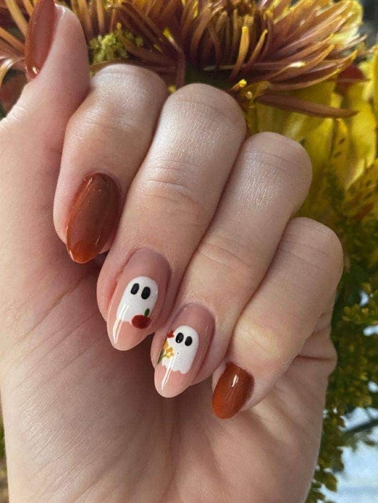 Rust and terracotta nails with cute little ghost accents