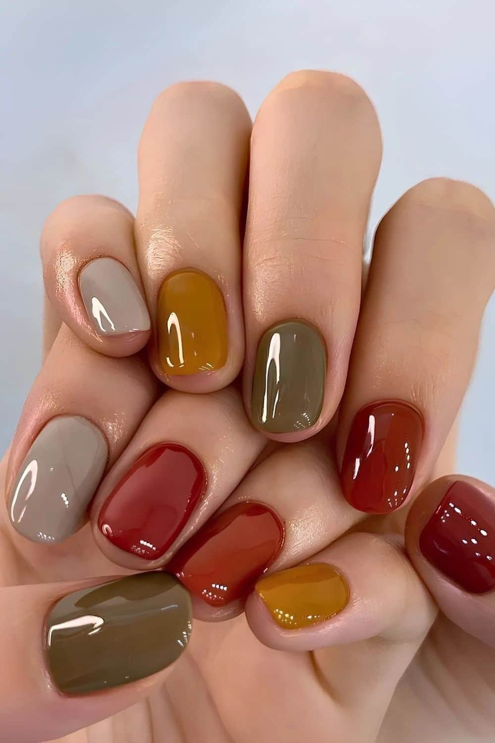 Mismatched fall nail colours in taupe, mustard, olive, rust and red