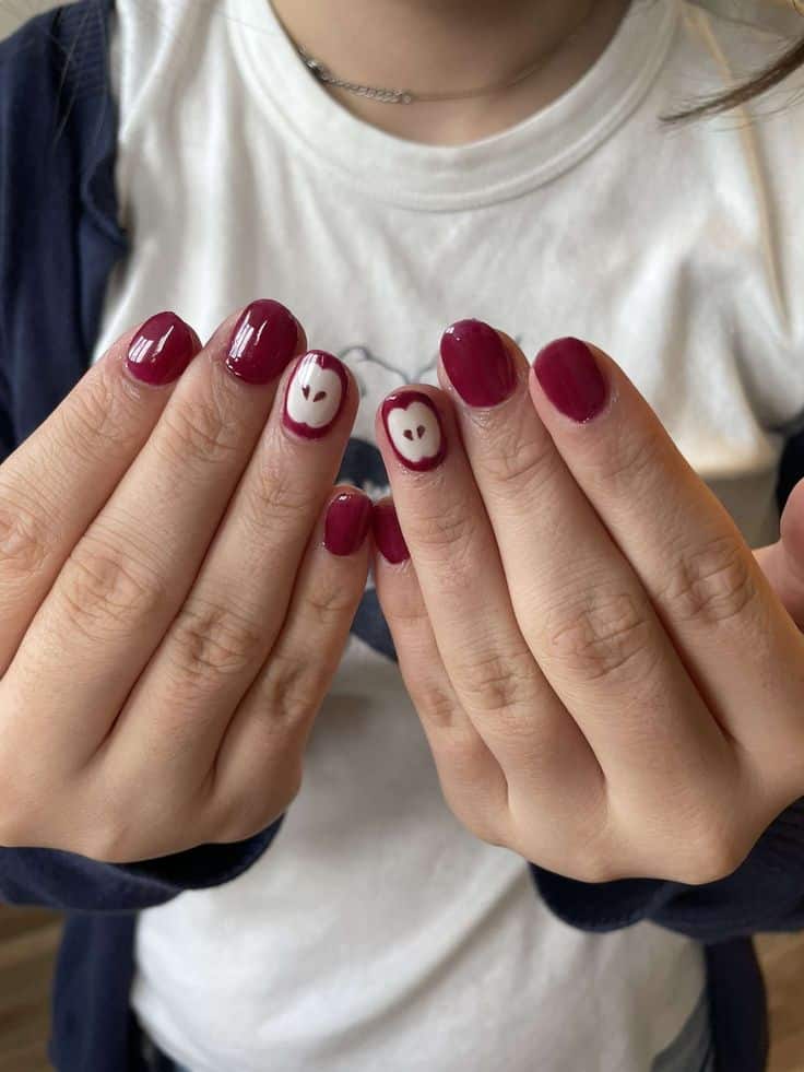 Raspberry pink fall nails with white apple accents