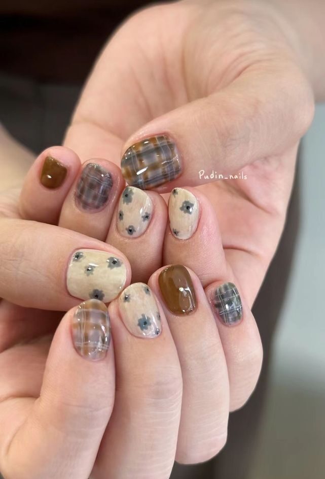 Muted grey and lilac plaid nails with tiny painted flowers