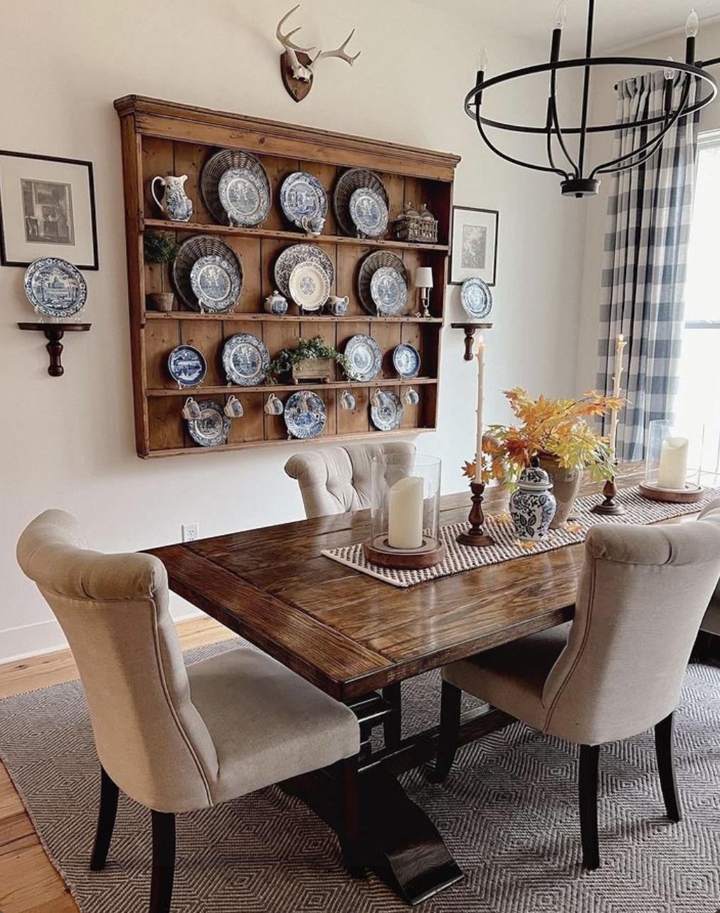 Large wooden plate rack above a dining table displaying a blue and white china collection