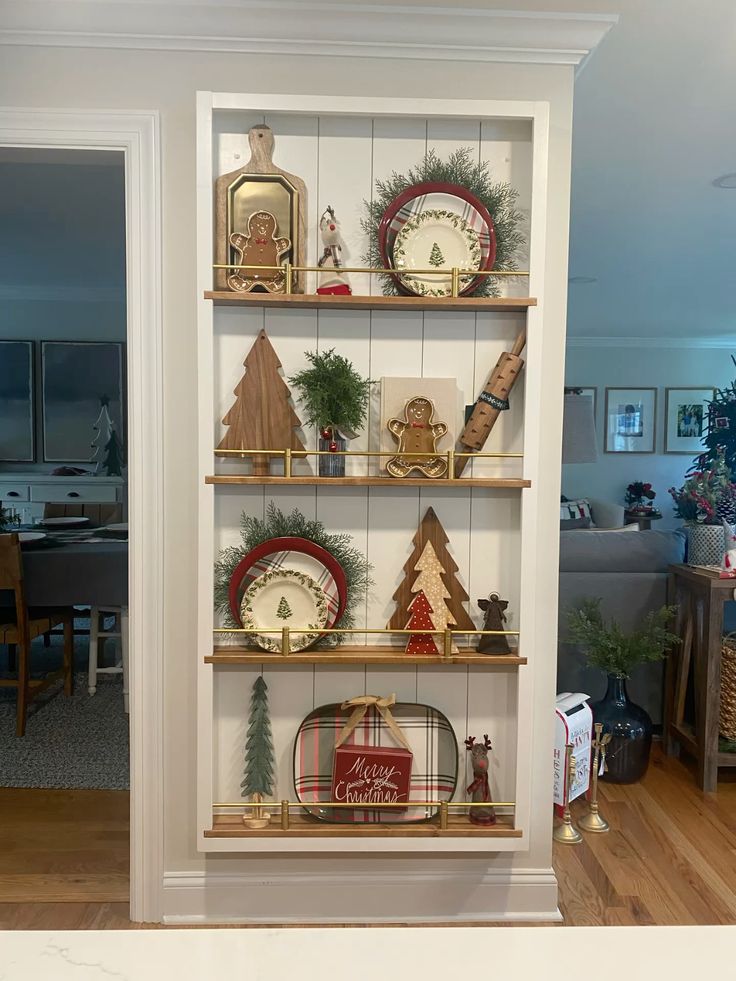 Shiplap plate rack wall with brass rails styled with Christmas plates and gingerbread decor