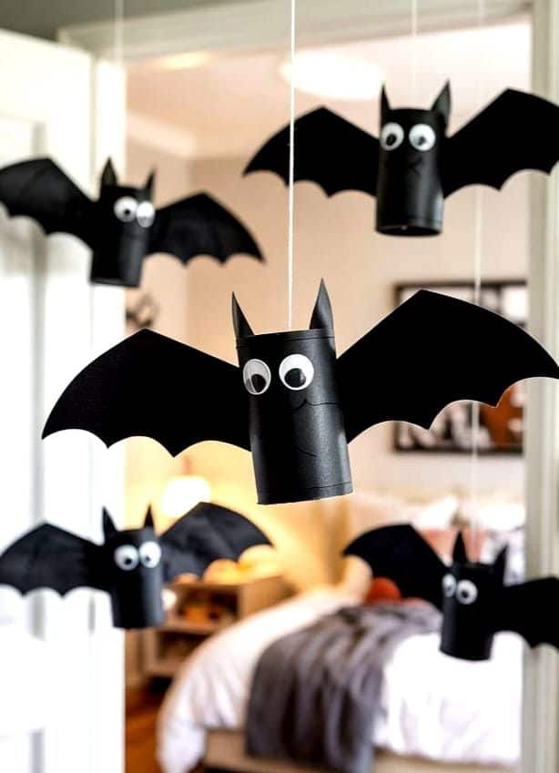 Hanging bats made from cardboard tubes with black paper wings and googly eyes