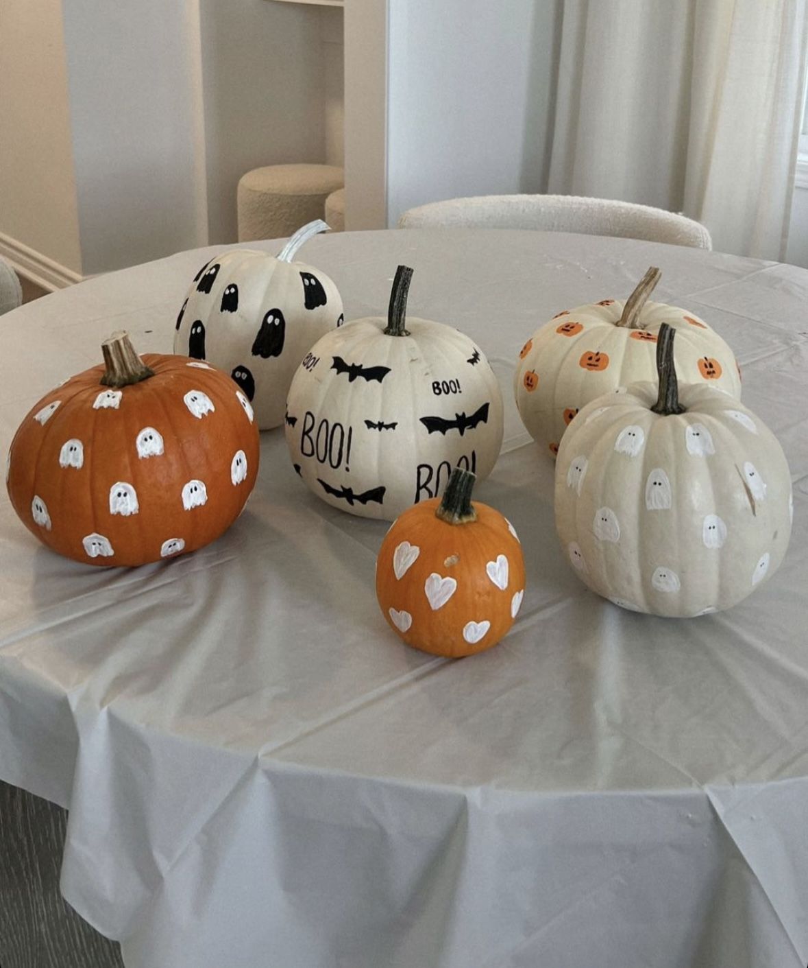 Small pumpkins hand-painted with ghosts, bats, hearts and BOO lettering