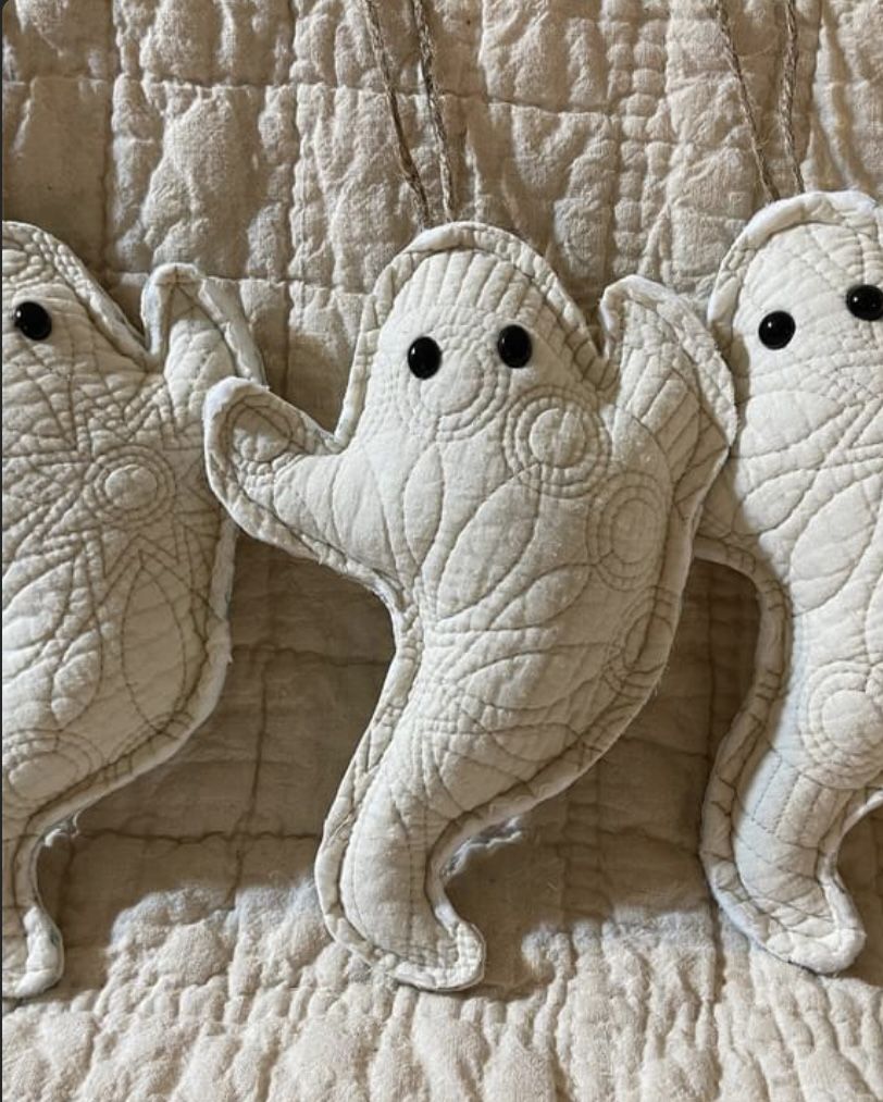 Stuffed ghost ornaments made from vintage quilt fabric with black bead eyes