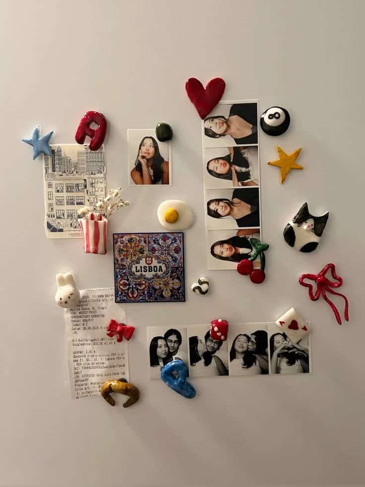Personalised clay letter magnets with hearts, cherries and a cat arranged among polaroid photos on a fridge
