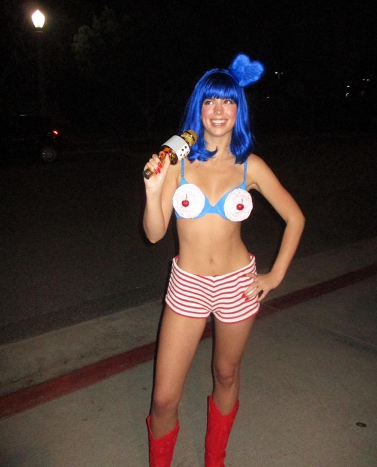 Person in a blue wig and cupcake-themed bra with red-and-white striped shorts and red boots, dressed as Katy Perry's California Gurls.