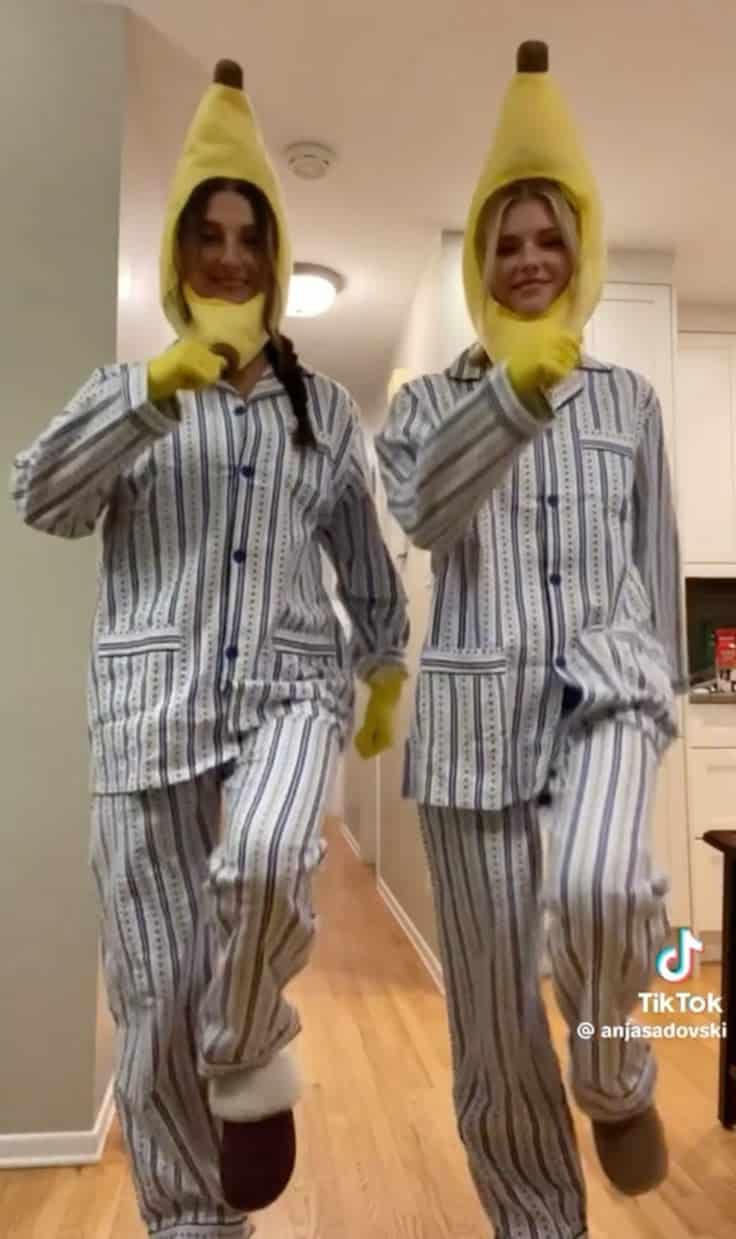 Two people in striped pyjamas and banana hoods dressed as Bananas in Pyjamas