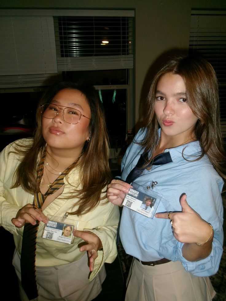 Two friends as Jim and Dwight from The Office holding Dunder Mifflin ID badges