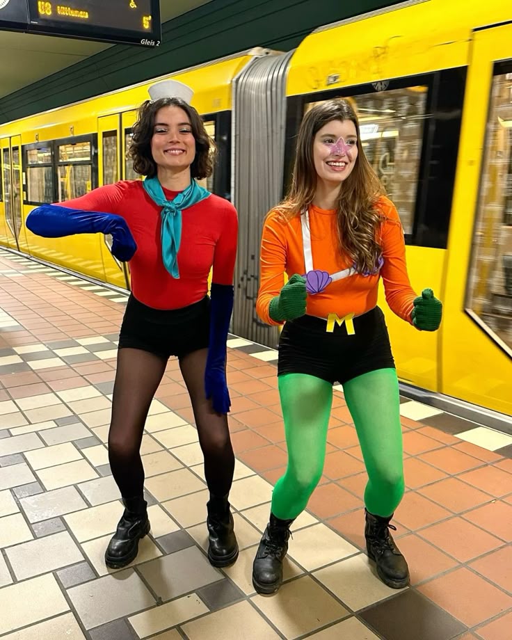 Two people dressed as Mermaid Man and Barnacle Boy from SpongeBob in bright red and orange
