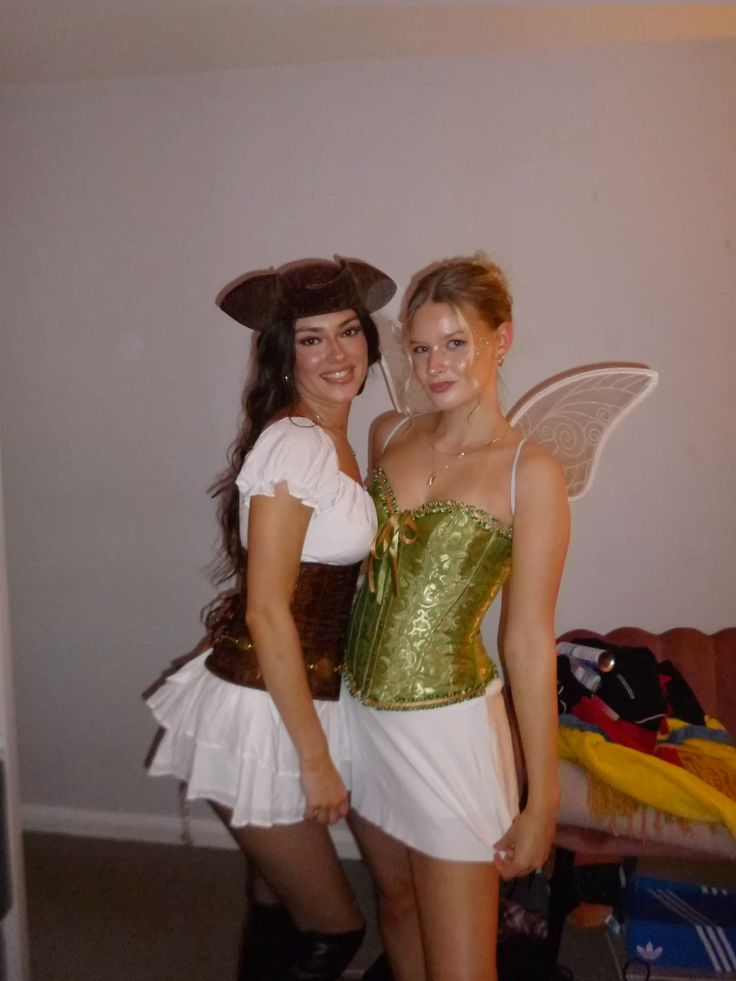 Two friends dressed as Captain Hook in a tricorn hat and Tinker Bell in a green corset with fairy wings, from Peter Pan