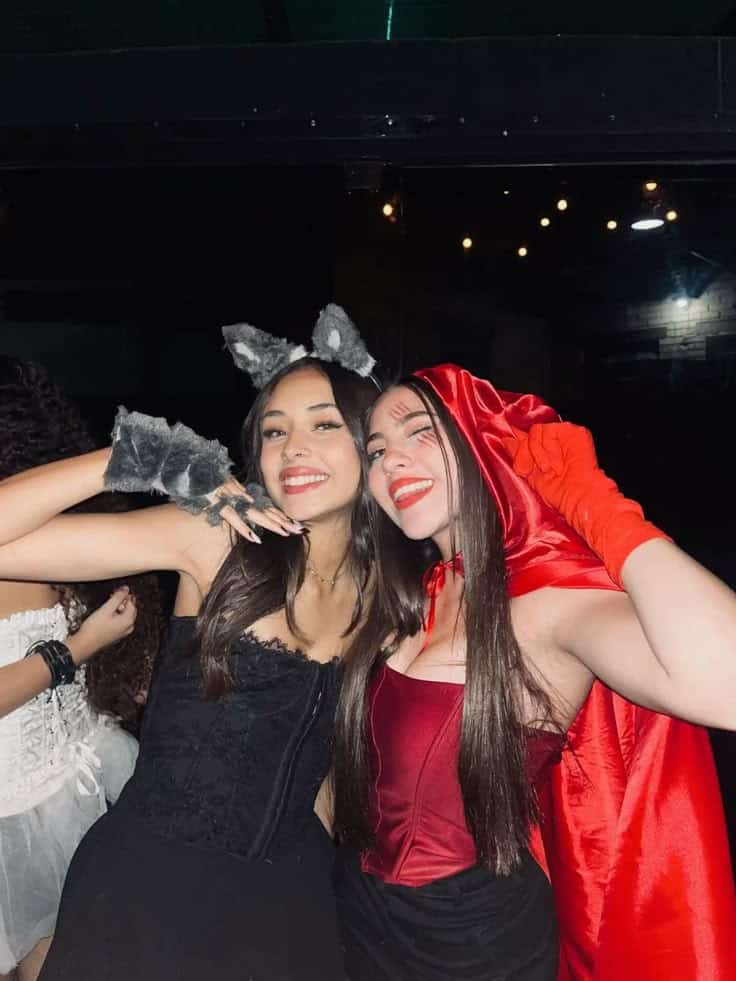 Two friends as the Big Bad Wolf with grey ears and paws and Little Red Riding Hood in a red cape