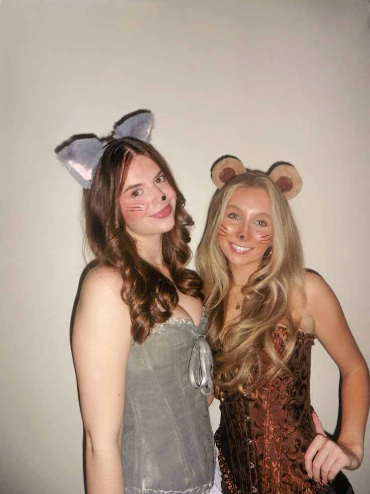 Two friends with grey cat and brown mouse ear headbands and painted whiskers dressed as Tom and Jerry