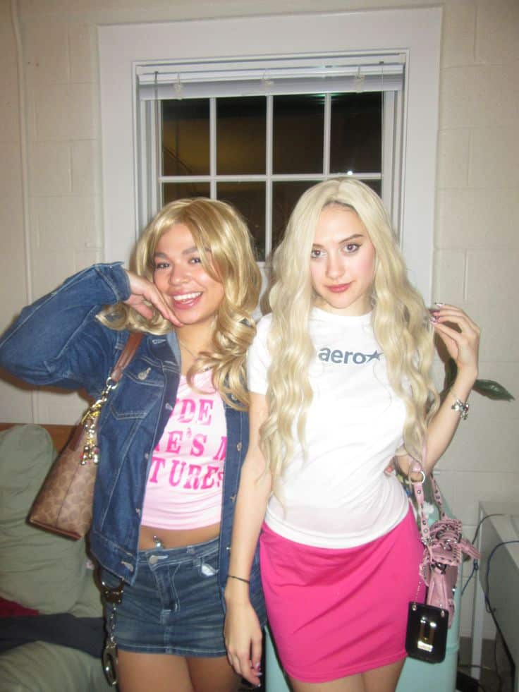 Two people in blonde wigs, denim and a pink skirt dressed as the Wilson sisters from White Chicks