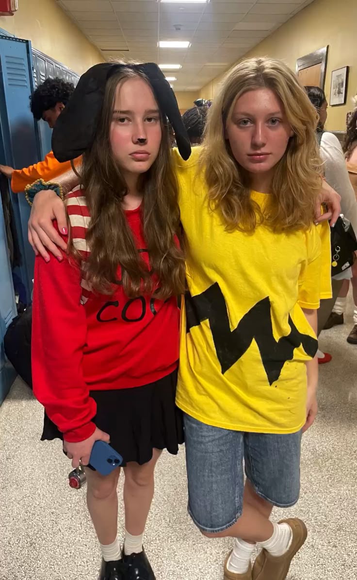 Two friends as Charlie Brown in a yellow zigzag tee and Snoopy in a red top with a floppy dog-ear hat