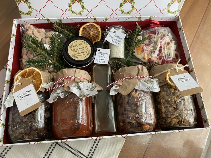 Festive gift box filled with homemade granola jars, infused olive oil, herb salt, BBQ rub and chocolate bark