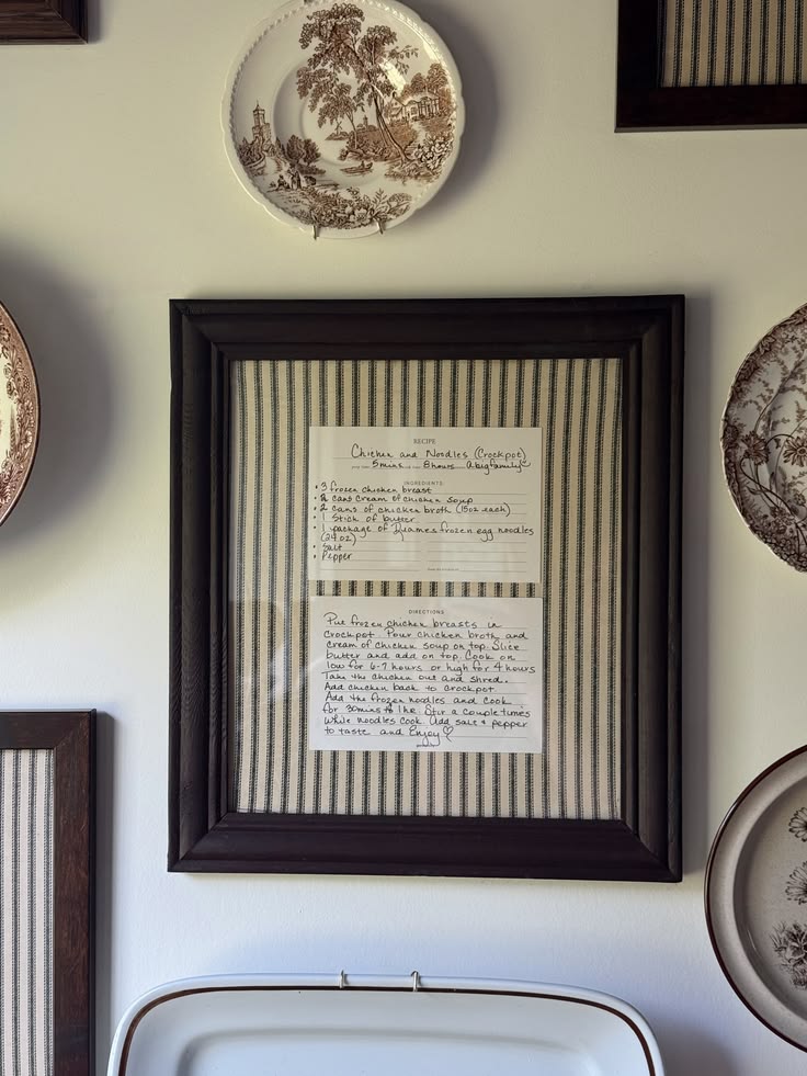 Handwritten family recipe framed on ticking stripe fabric in a dark timber frame