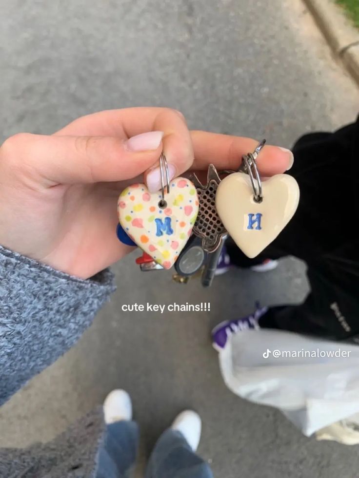 Two hand-painted clay heart keyrings with blue initials