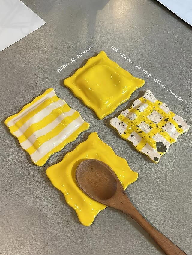 Ceramic spoon rests shaped like ravioli in yellow, stripes and speckled gingham