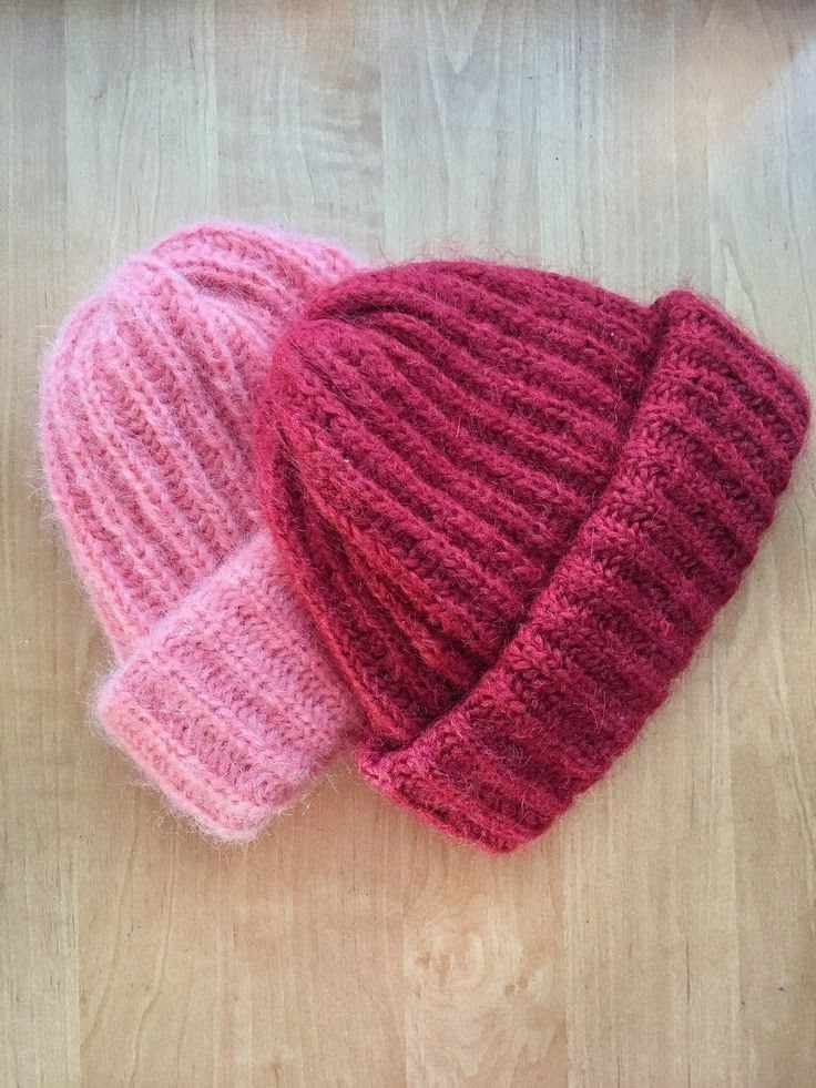 Two fluffy ribbed knit beanies in pink and raspberry