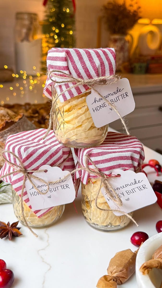 Cut-glass jars of whipped honey butter topped with red striped fabric and twine tags
