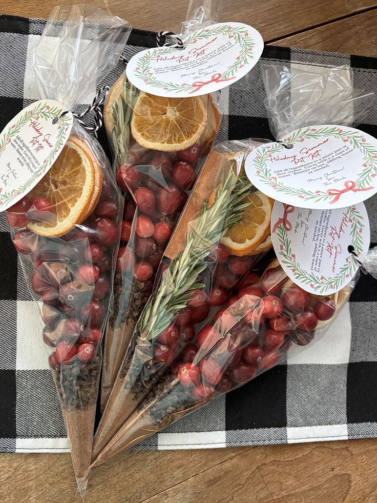 Holiday simmer pot kits in clear cone bags with cranberries, dried orange, rosemary and cinnamon